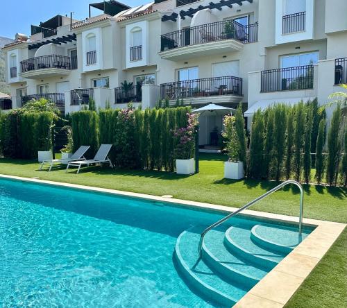 a swimming pool in front of a building at Onda in Denia