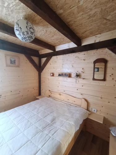a bedroom with a bed in a wooden room at Stevanova brvnara in Zlatibor