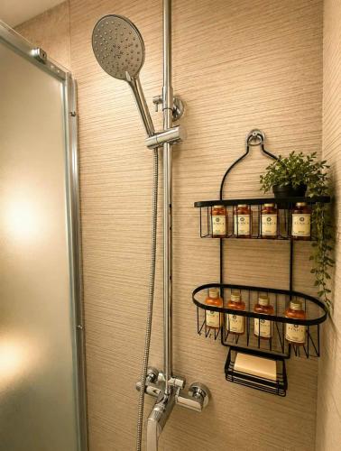 ein Badezimmer mit Dusche und einem Regal mit Kerzen in der Unterkunft TheAiryLoft in Mytilini