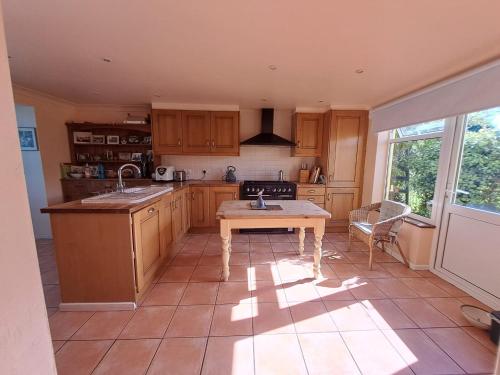 a kitchen with wooden cabinets and a table in it at Character Cottage in Wallingford in Wallingford