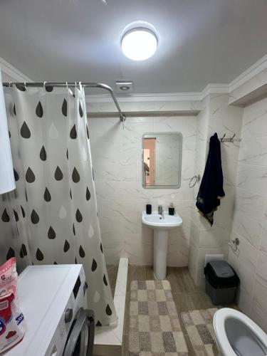 a white bathroom with a sink and a toilet at Атлантис in Chon-Sary-Oy