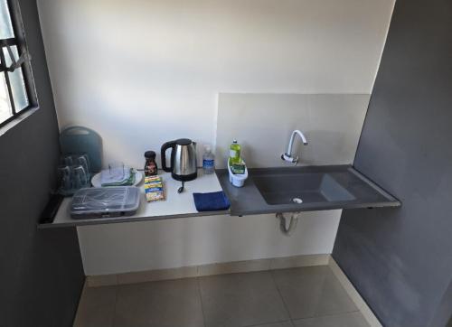 a kitchen counter with a sink in a room at Microcasa 6 in Lajeado