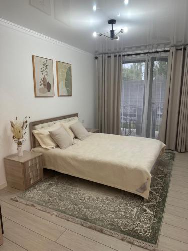 a bedroom with a large bed and a window at Атлантис in Chon-Sary-Oy