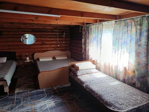 a room with two bunk beds and a window at Синие домики in Borovoye