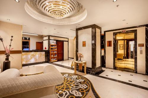 a living room with a couch and a chandelier at The central hotel in Istanbul