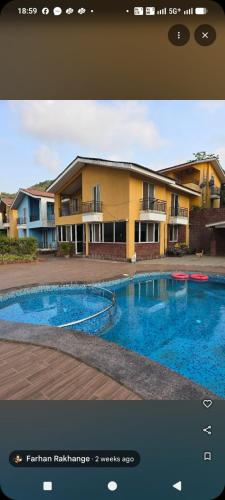 a picture of a swimming pool in front of a building at Casa asud Dapoli in Dapoli