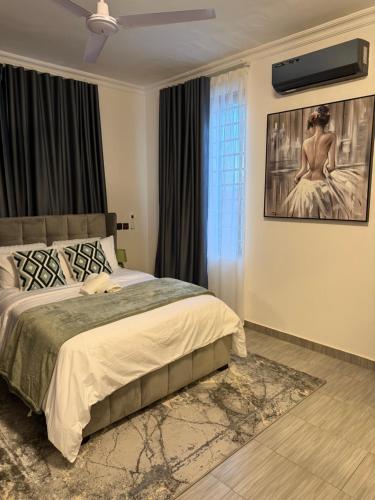 a bedroom with a bed and a window at F&F Villa in Tema