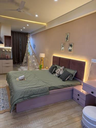 a bedroom with a large bed in a room at The cozy cave in Jaipur