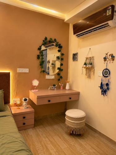 a bedroom with a dressing table and a mirror at The cozy cave in Jaipur