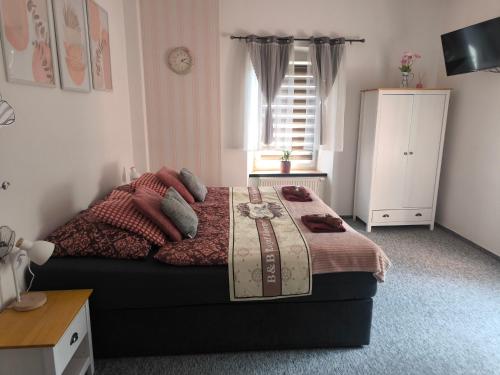 a bedroom with a bed with a table on it at B&B Royal Liberty in Ústí nad Labem