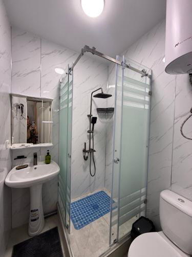 a bathroom with a shower and a sink at Wings Zen in Bosteri