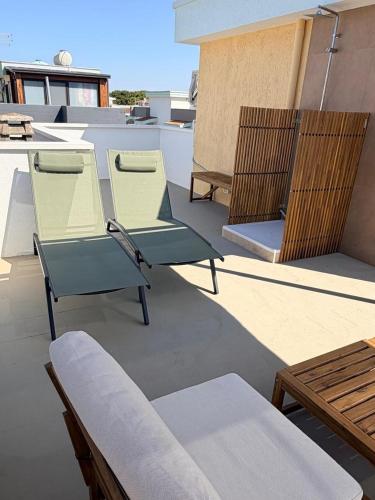 a group of chairs sitting on top of a roof at Dune House in Ginosa Marina