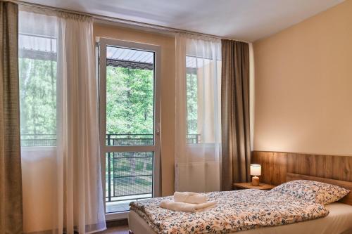 a bedroom with a bed and a large window at Brido in Bardo