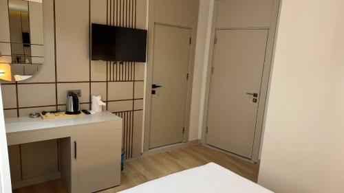 a small bathroom with a sink and a mirror at Nergiz Boutique Hotel in Antalya
