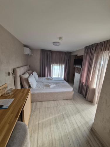 a hotel room with a bed and a desk at Hotel PERLA BEACH in Sozopol