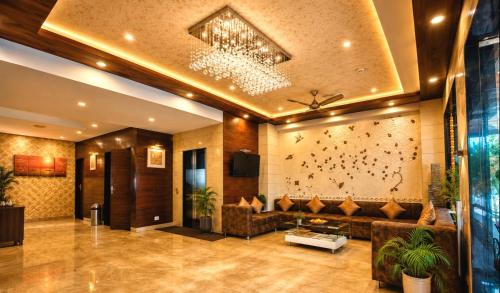 a lobby with a couch and a wall with birds on it at Opulence Inn - 500 Meters From Railway Station in Udaipur