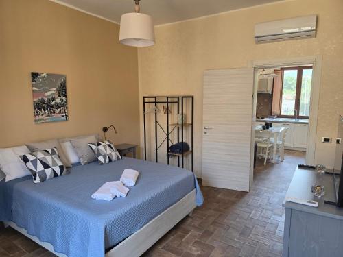 a bedroom with a bed with two towels on it at Risorta Ponente in Boiano