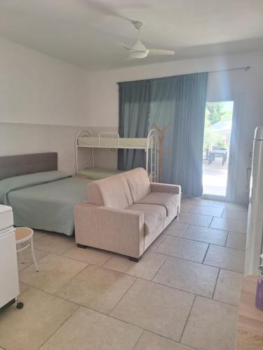 a living room with a couch and a bed at Da zia Sofia in Torre Lapillo