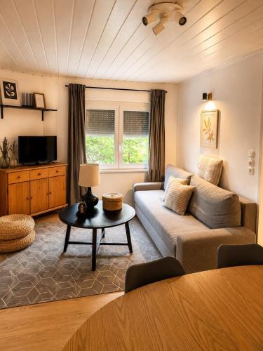 a living room with a couch and a table at Lugas Apartman in Harkány