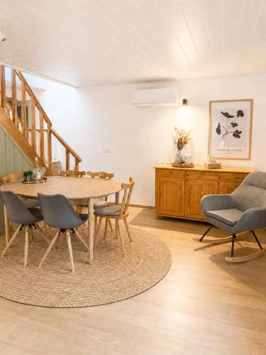 a dining room with a table and chairs at Lugas Apartman in Harkány