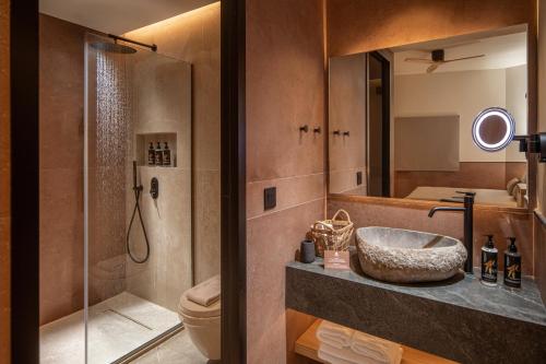 a bathroom with a sink and a toilet and a shower at Esperides Resort Crete, The Authentic Experience in Hersonissos