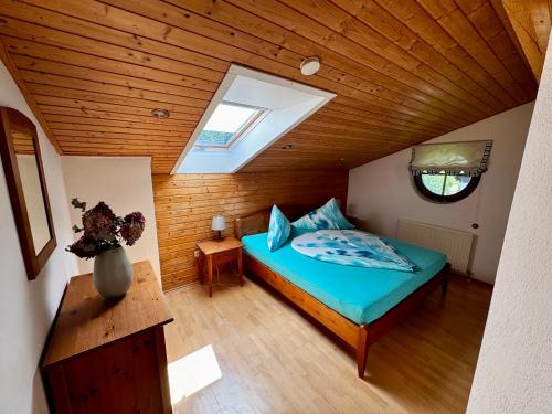 a bedroom with a bed and a skylight at Landhaus Zoppoth in Kötschach
