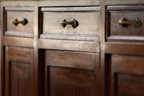 a pair of wooden cabinet doors with bronze handles at Feudo Vagliasindi -Wine Experience- in Randazzo