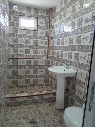 a bathroom with a sink and a toilet at Guest house Tea in Kvareli