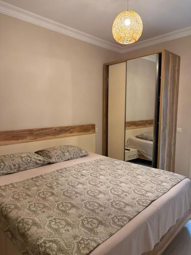a bedroom with a bed and a large mirror at Vacation Home Nukri in Gonio