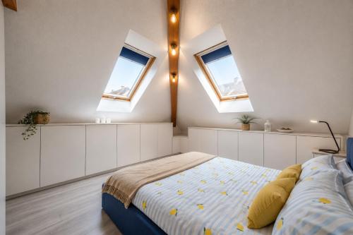 a bedroom with two skylights and a bed in it at ACME Apartments in Budapest