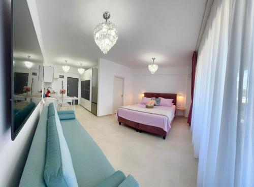 a bedroom with a bed and a chandelier at Saturn ROOMS in Saturn