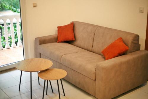 a living room with a couch and two tables at Apartman Vujović Orahovac in Trstenik