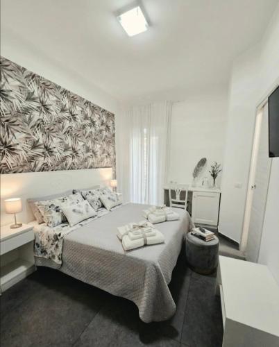 a bedroom with a large bed with towels on it at ALBATROS Suites&Rooms in Naples
