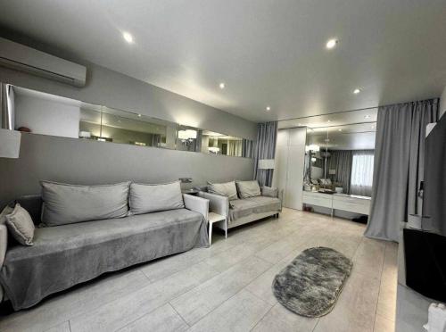 a large living room with a couch and a table at Білі апартаменти in Dnipro