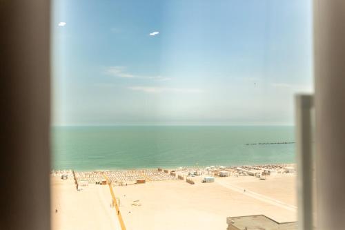 a view of a beach with chairs and the ocean at Hotel Riviera in Mamaia