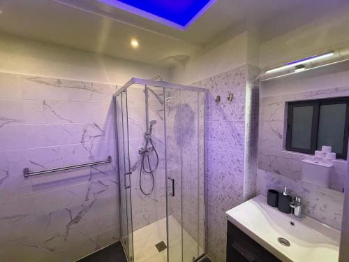 a bathroom with a shower and a sink at Cardinal Rooftop Townhouse by Aureum in Birgu