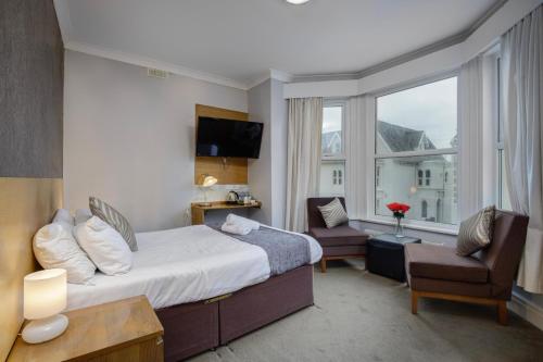 a hotel room with a bed and a window at Ashley Victoria in Blackpool