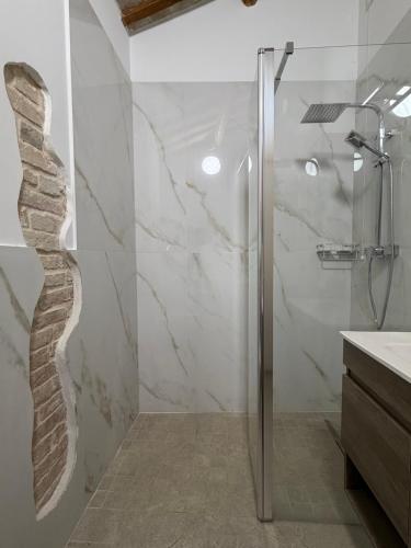 a bathroom with a shower with a glass door at Casa Alfio in Centobuchi