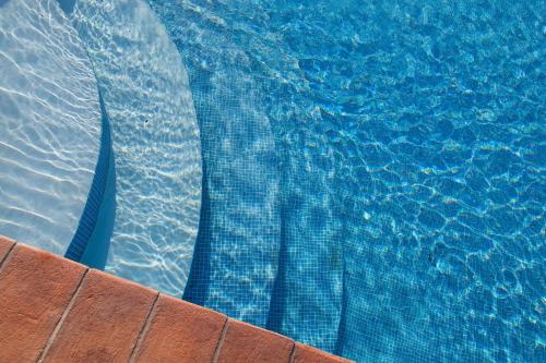 a close up of a swimming pool with blue water at Feudo Vagliasindi -Wine Experience- in Randazzo