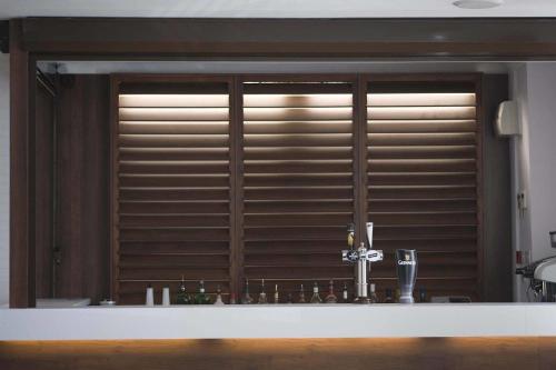 a kitchen with a window with blinds at Ashley Victoria in Blackpool