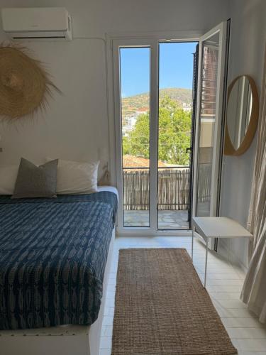 a bedroom with a bed and a view of a balcony at St Pauls Batsi in Batsi