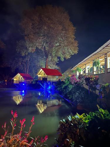 a pond with blue lights in front of a building at El portal de Bariloche in Ibagué