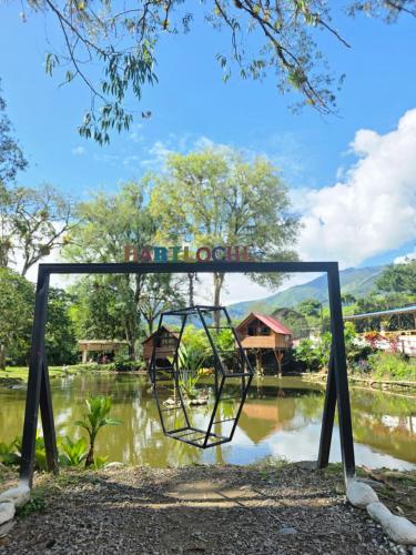 a sign in front of a body of water at El portal de Bariloche in Ibagué
