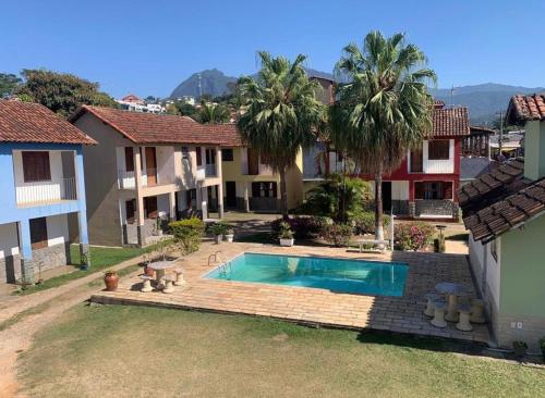 a swimming pool in the backyard of a house at Pousada Recanto Penedo in Penedo