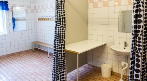 a small bathroom with a sink and a shower at Norbergs Camping in Norberg