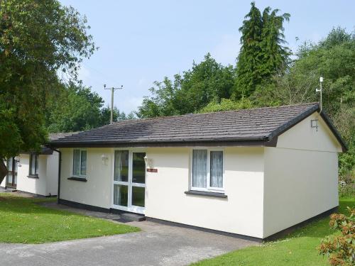 a white cottage with a black roof at Trevarno - B6527 in Saint Cleer
