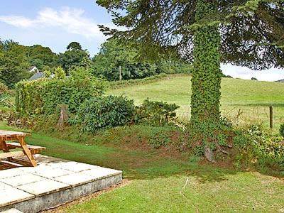 a picnic table next to a tree in a field at Tresco - B6520 in Saint Cleer