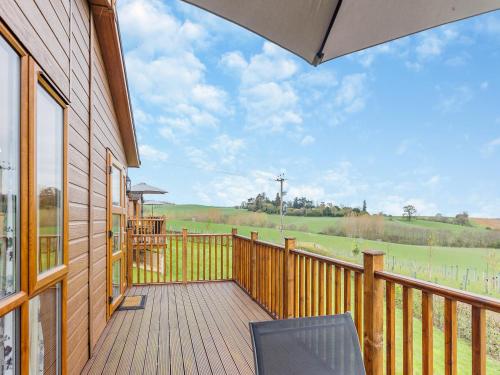 a wooden balcony with a view of a field at Park View - Uk46898 in Kinlet