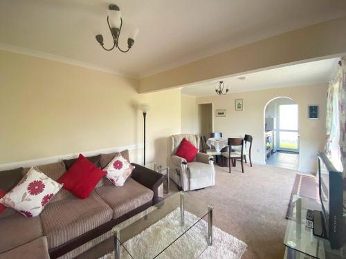 a living room with a couch and a dining room at Eden - B6526 in Saint Cleer