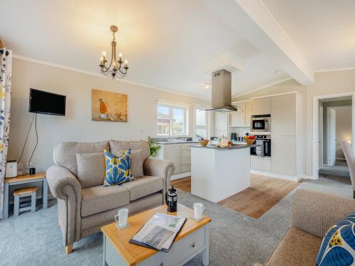 a living room with a couch and a table at Winnal View - Uk46891 in Kinlet
